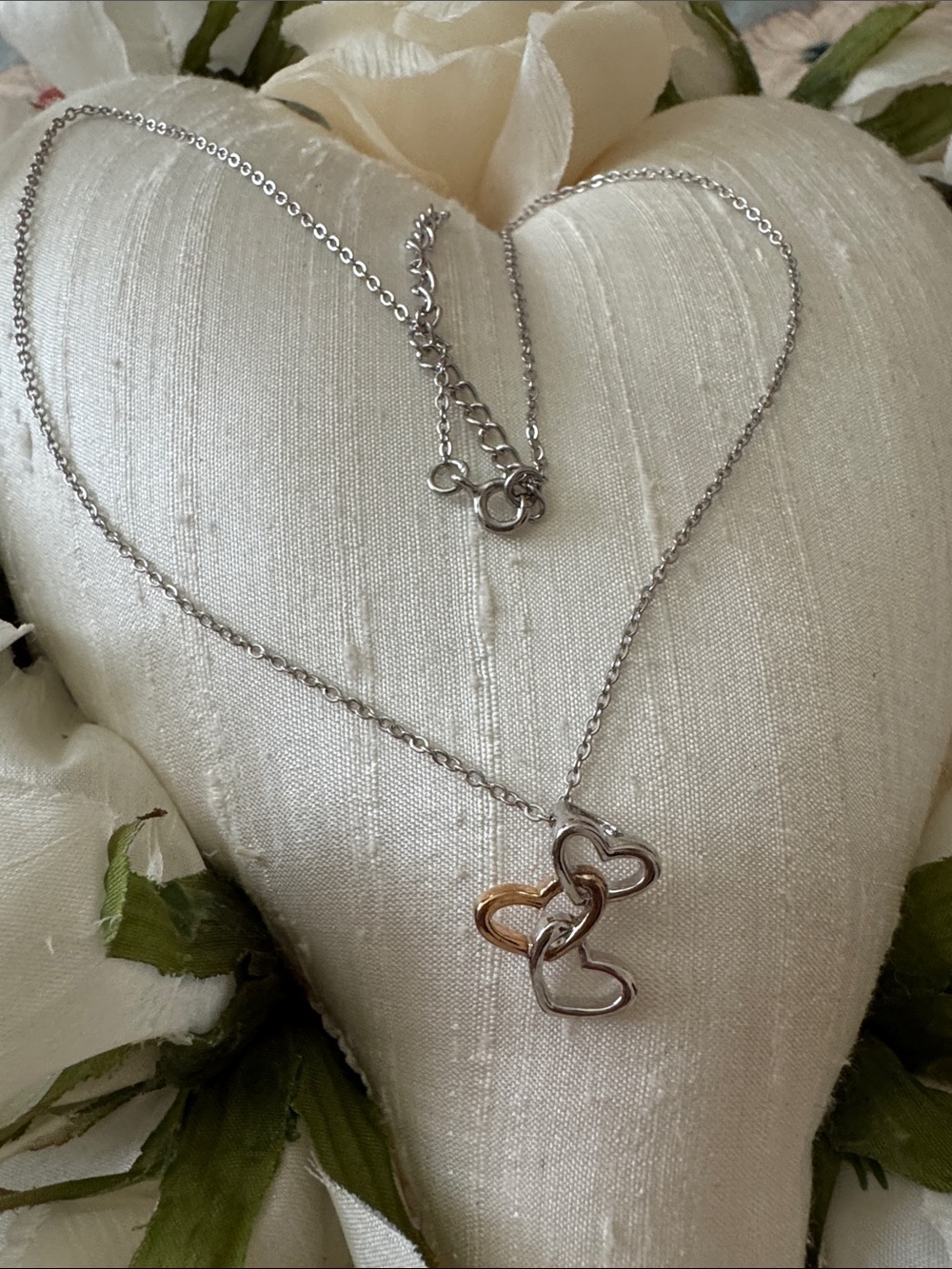 Sterling silver and gold plated three heart necklace.